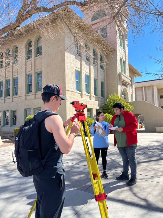NMSU Students working on survey equipment on campus