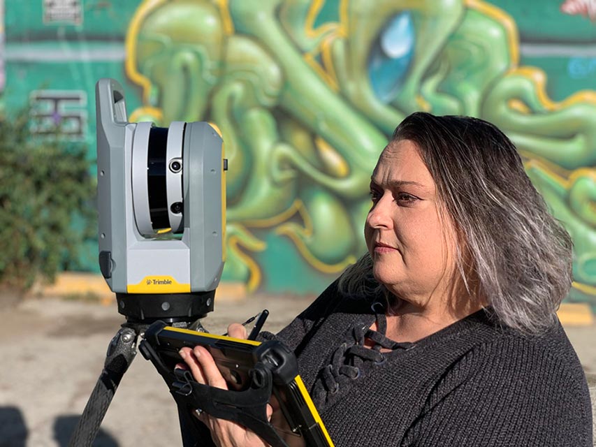 Stacy Jacobs working on a tablet in the field