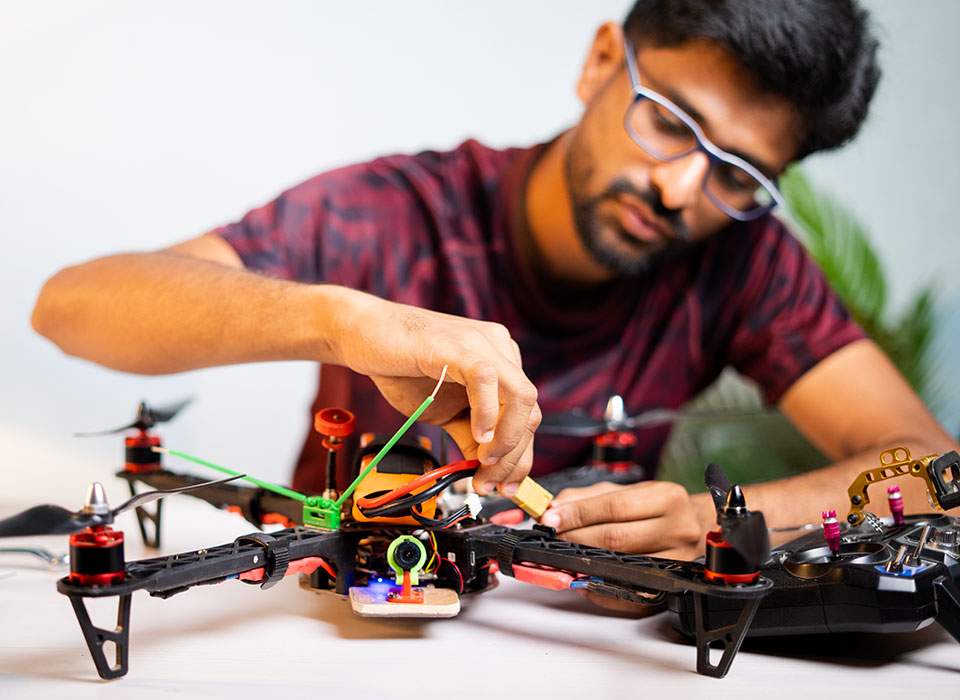international engineering student working on a drone